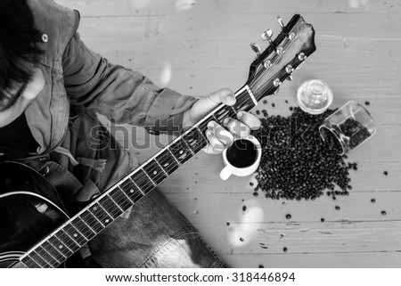 acoustic guitar and coffee on a wooden floor