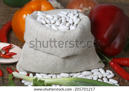 white beans with raw canvas bags.