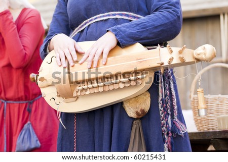 Woman playing a stringed instrument at \