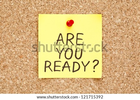 Are You Ready, written on an yellow sticky note on a cork bulletin board