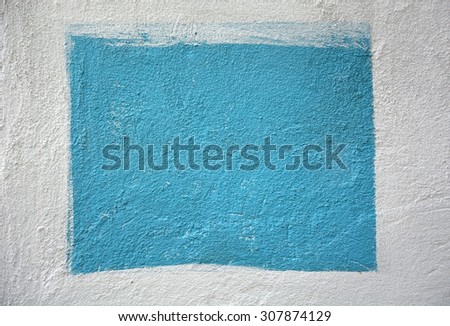 White cement wall with the area, painted blue. Background, texture
