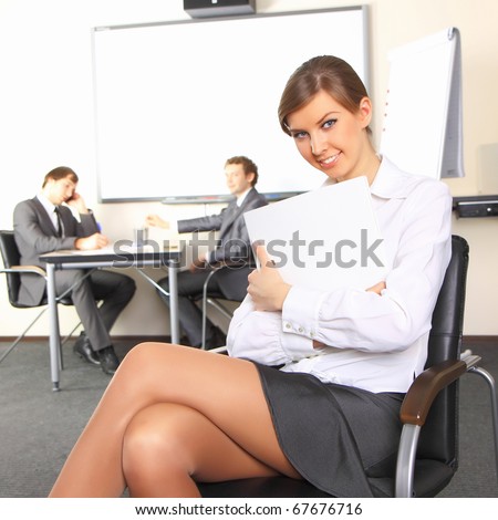 Portrait of business woman with team mates discussing in the background