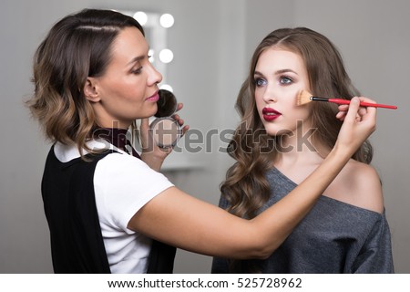 Similar – Image, Stock Photo Professional visagiste applying powder on model face