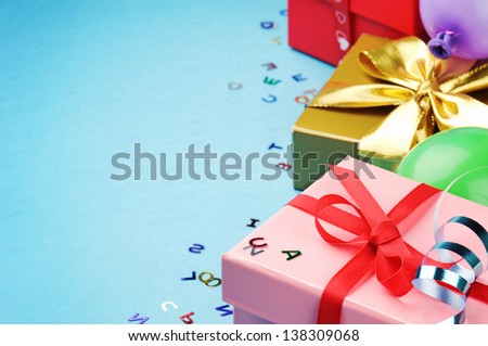 Colorful birthday gift boxes over blue background