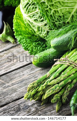 Fresh green vegetables on wooden table