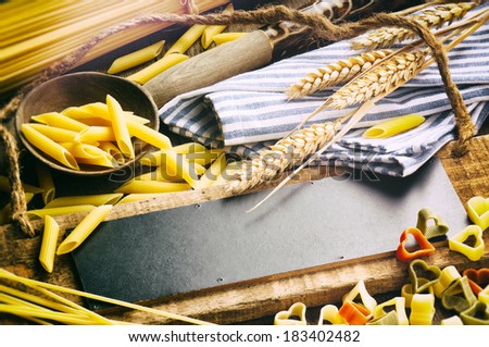 Rustic wooden board with pasta assortment