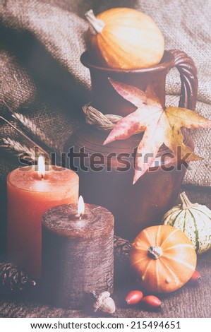 Autumn setting with candles and pumpkins in retro style