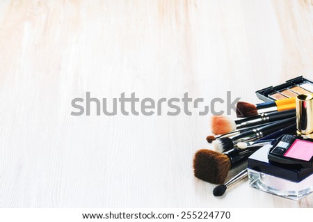 Various makeup products on light background with copyspace