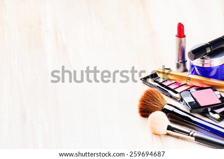 Various makeup products on light background with copyspace