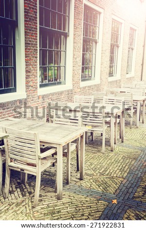 Cafe terrace in small European city at sunny day