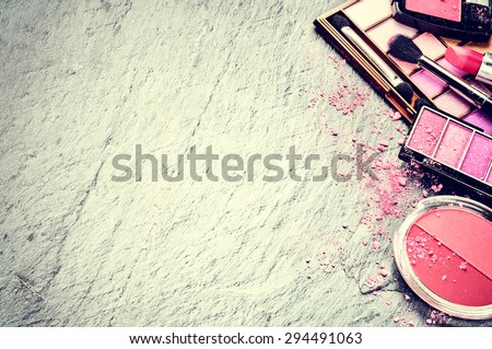 Various makeup products in pink tone with copyspace