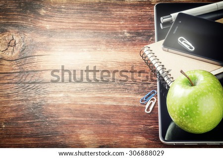 Desktop with tablet pc, smartphone and green apple. Copy space