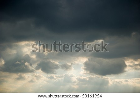 Sun rays streaming trough an opening of the clouds
