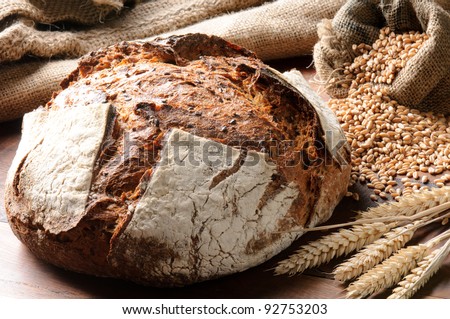 Freshly baked traditional bread on wooden table