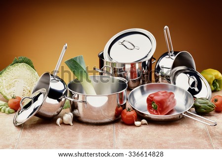 Set of Steel Pots and Covers with raw Ingredients Foto stock © 