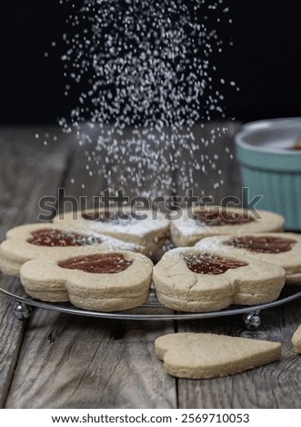 Similar – Image, Stock Photo Person sprinkling icing sugar over on cookies