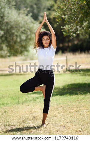 Similar – Image, Stock Photo Peaceful Arab woman doing yoga on embankment