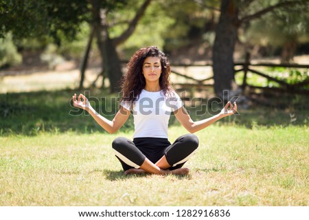 Similar – Image, Stock Photo Peaceful Arab woman doing yoga on embankment