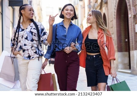 Similar – Image, Stock Photo Delighted female friends walking along street
