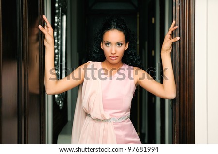 Portrait of a young black woman, model of fashion, with pink dress