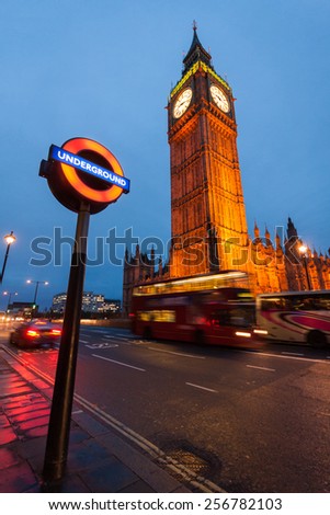 LONDON, 28 February 2015: The Underground Logo and The Big Ben in Westminster, shooted at the Blue Hour. London Underground has expanded to 11 lines, and in 2012/13 carried 1.23 billion passengers