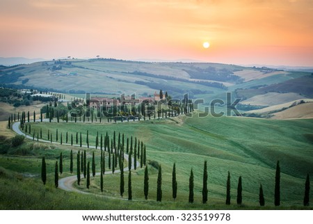 Crete Senesi, Tuscany, Italy. A lonely farmhouse with cypress and olive trees, rolling hills, Tuscany, Italy. A lonely farmhouse with cypress and olive trees, rolling hills.