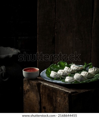The history of momo in Nepal dates back to as early as the fourteenth century. Momo was initially a Newari food in the Katmandu valley.  Stock fotó © 