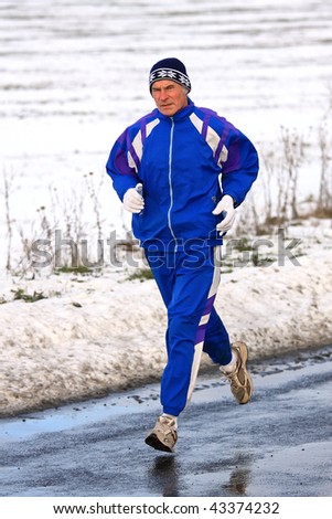 Senior runner while training for a competition in winter