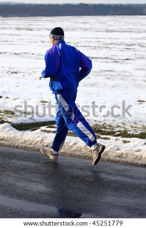 Senior runner while training for a competition in winter