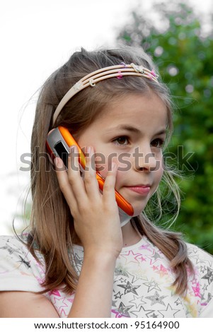 Nice girl while receiving some interesting news on the phone
