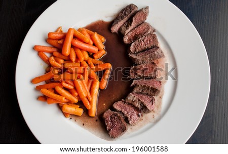 Lamb saddle on port wine with young carrots