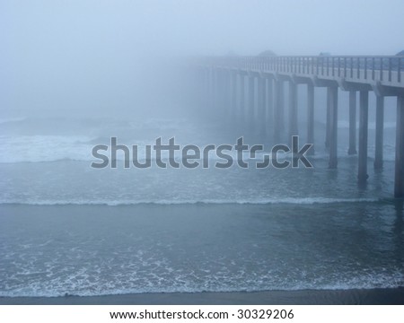 Ocean pier, disapearing in the fog