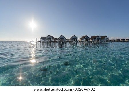 wide angle of luxury over water bungalow, water villa lagoon in the sea