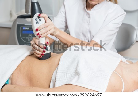 Cosmetician  making procedure of lymphatic drainage with a professional equipment