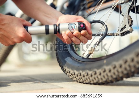 Similar – Image, Stock Photo Woman inflating bicycle tire in workshop