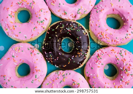 Donut with Pink and Black on a Polkadot Background