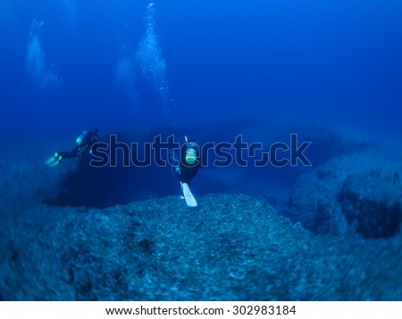 Exploring divers in the deep sea scuba diving Okinawa,Japan