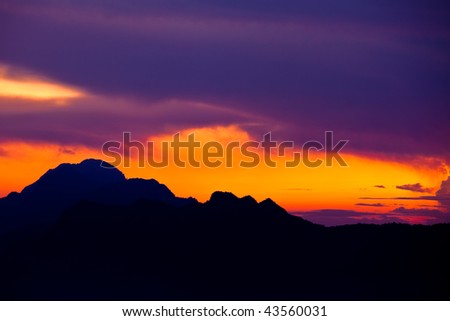 dramatic sky over mountain silhouette