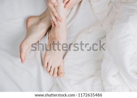 Similar – Image, Stock Photo Flatlay of woman rubbing cream in her legs in bed