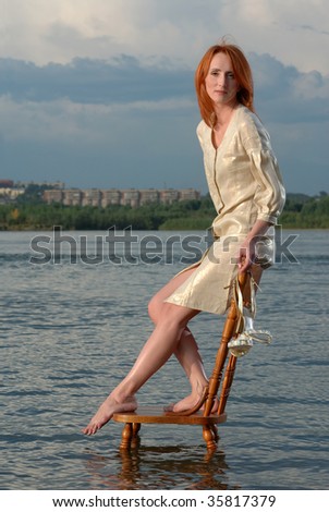 Portrait of beautiful woman on chair in river water