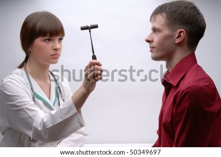 Young doctor inspecting patient\'s nervous system