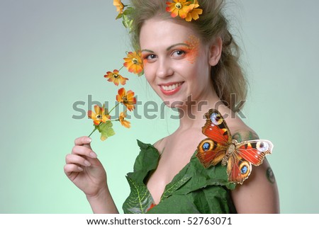 Portrait of forest nymph with butterfly on her shoulder