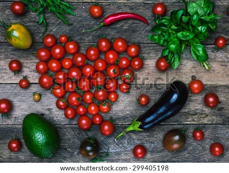 Tomato heart shape and vegetables as healthy eating concept on wooden table it rustic style
