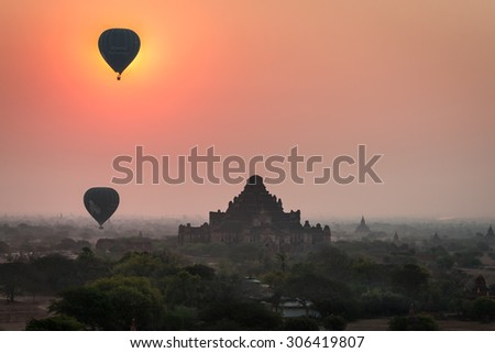 BAGAN, MYANMAR- MARCH 10, 2015: The tourists\' balloons and the sunrise over Bagan.