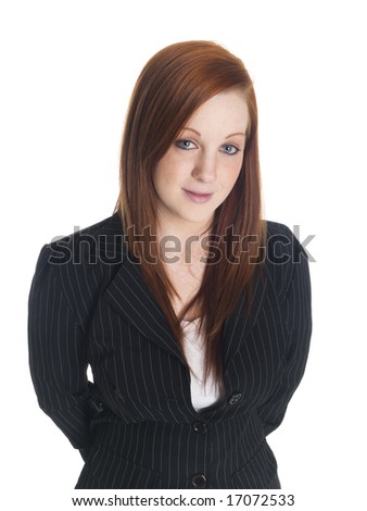 Isolated studio shot of a confident businesswoman with her hands clasped behind her back.