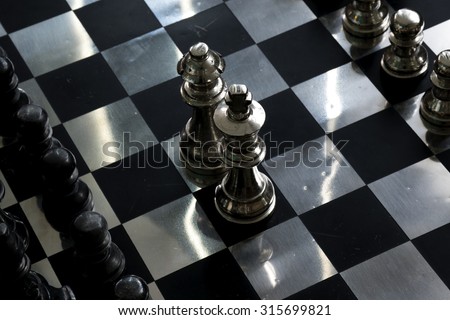 Metallic chess board: king and queen