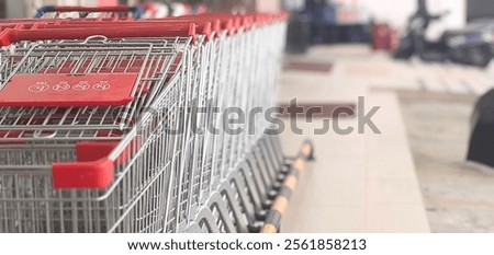 Similar – Image, Stock Photo Shopping carts arranged in the parking and entrance area of a giant warehouse supermarket, on the outskirts of Zaragoza city, Spain.