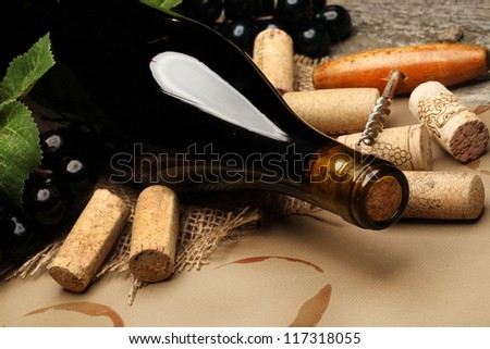 Wine Cork, Corkscrew and red wine stains on the  paper background