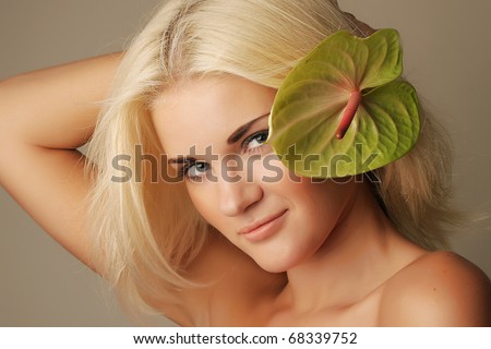 Photo of beautiful sexy woman with blond hair and flower