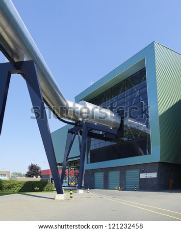 exterior of a modern waste treatment plant with giant pipes